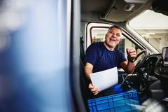 Photo of a truck driver sitting in his truck