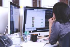 woman sitting at computer, view from behind