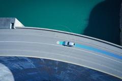 car driving on road with blue line