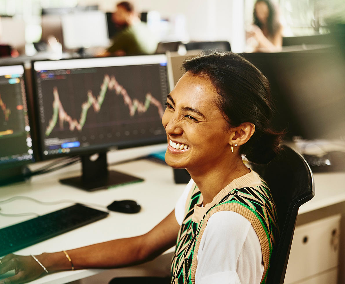 smiling woman in front of digital data dashboard